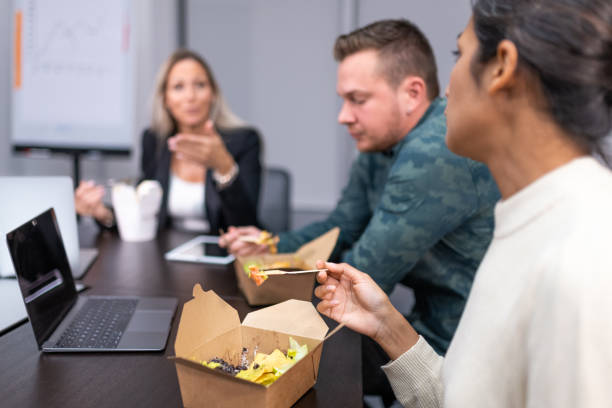 istock Colleagues having lunch during a meeting 1352139171