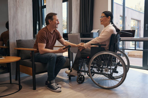 istock Cheerful man enjoying communication with woman with disability 1352139693