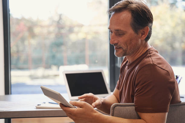 istock Mature man is using calculator and laptop 1352139702