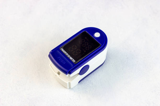 medical fingertip pulse oximeter tool for oxygen saturation check during covid virus desease. spo2 monitoring and heart rate measurement instrument on light background - taking pulse oximeter medical oxygen equipment human lung imagens e fotografias de stock