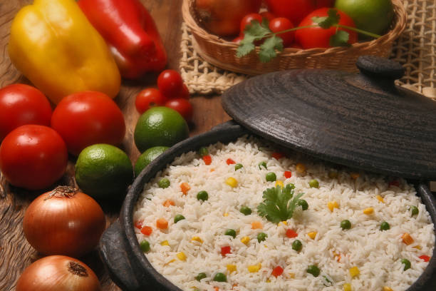 istock Appetizing healthy rice with vegetables in white plate on a wooden background 1352140805