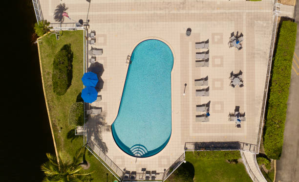 istock A top down drone view over an empty pool, surrounded by green grass and trees on a sunny day in Florida. 1352141734