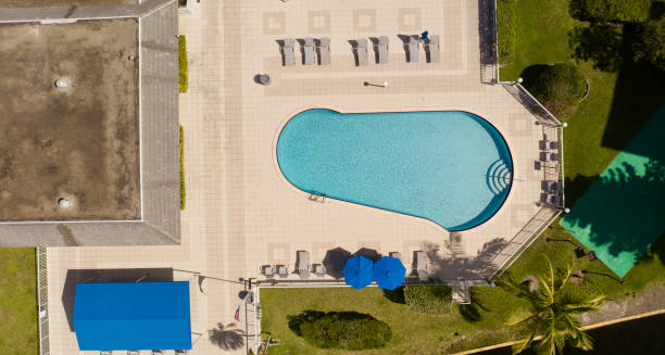 istock A top down drone view over an empty pool, surrounded by green grass and trees on a sunny day in Florida. 1352141737