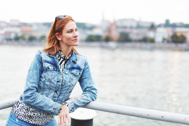 istock Young redhead woman posing at riverbank horizontal 1352144780