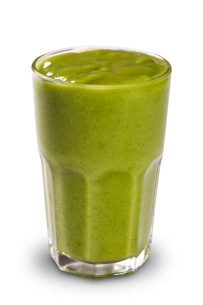 istock Green smoothie in a glass with straws isolated on a white background 1352147583