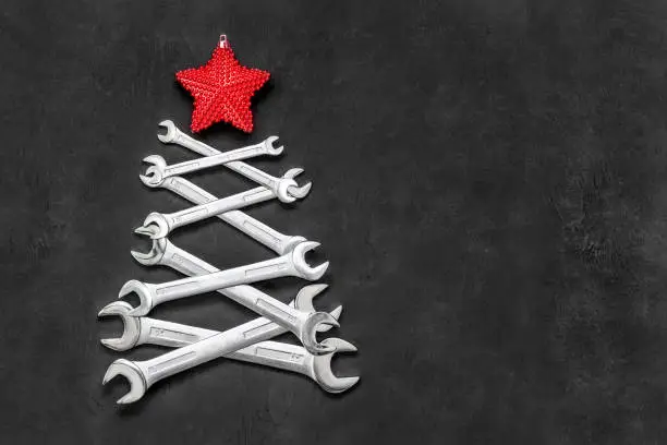 Photo of Christmas tree made from steel tools. Happy new year and merry christmas holiday. Copy space