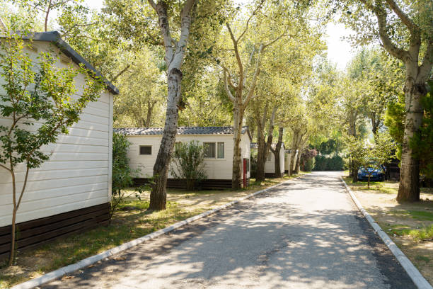 Vacation mobile houses on a campsite with trees around Vacation mobile houses on a campsite with trees around manufactured housing stock pictures, royalty-free photos & images