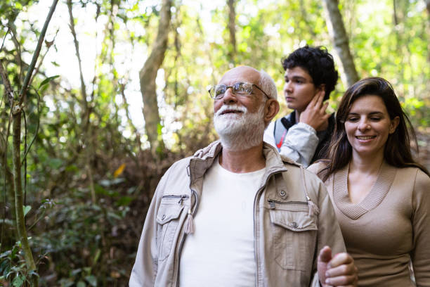 istock Three-generation family walking in nature 1352151101