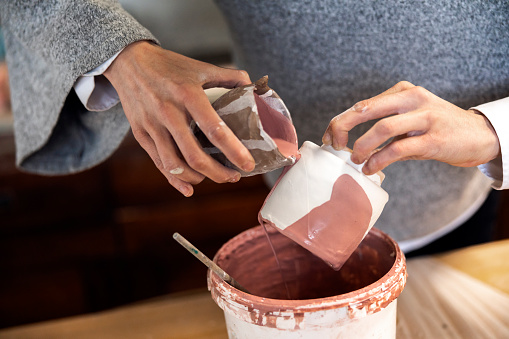 Ceramic pottery hand making - Putting glaze on item