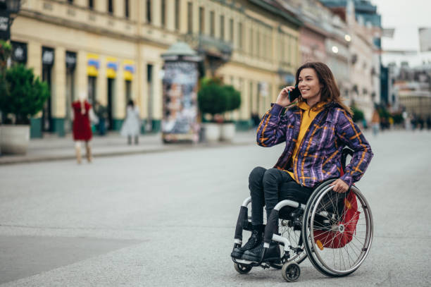 istock Woman with disability using a smartphone while out in the city 1352152272