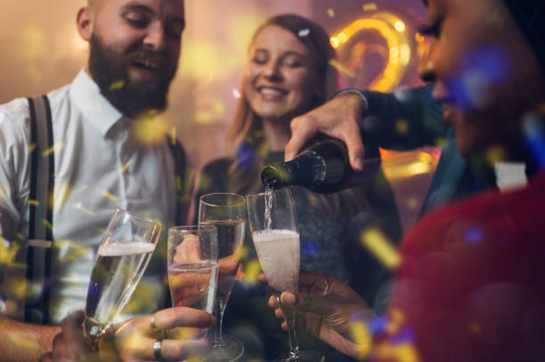 istock Friends celebrate New Year's Eve while drinking champagne 1352152329