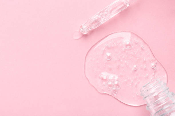 istock Small bottle and glass pipette with clear gel on light pink 1352152554