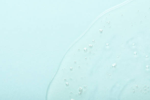 istock Clear anti-aging serum spilled onto turquoise background 1352152555