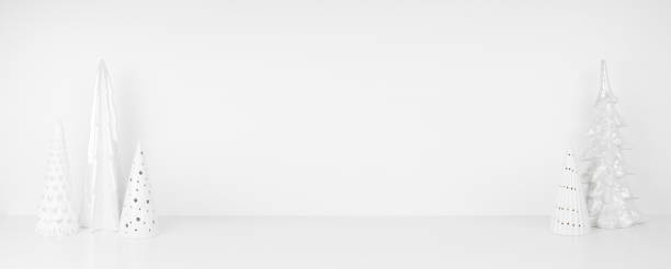 istock White Christmas tree decor on a shelf against a white wall banner background 1352157579