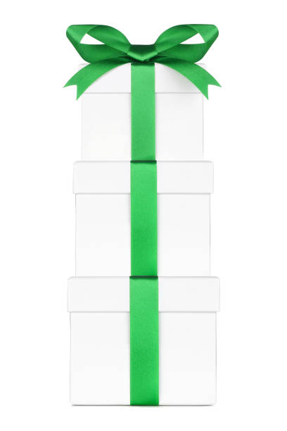 istock Stacked white gift boxes wrapped with green bow and ribbon isolated on white 1352157749