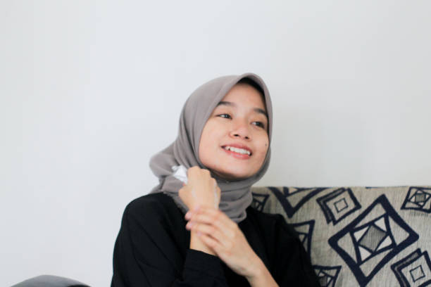 istock young women using skin care at home 1352158047