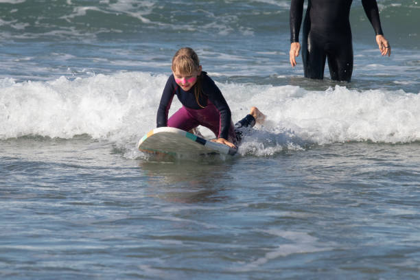 istock A little girl standing on the surfboard 1352160736