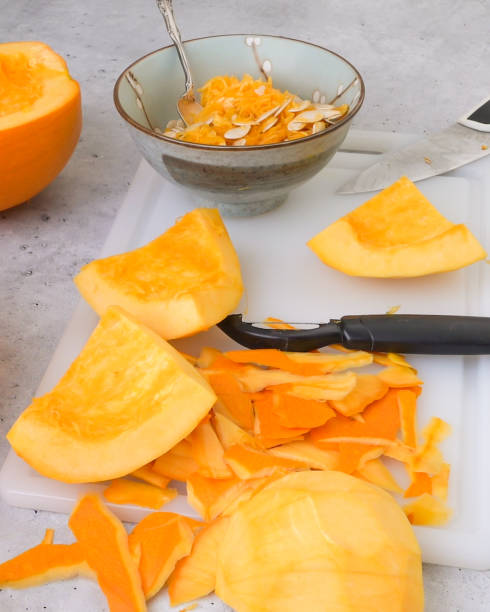 istock Peeled raw pumpkin slices close up on cutting board, vertical banner 1352161697