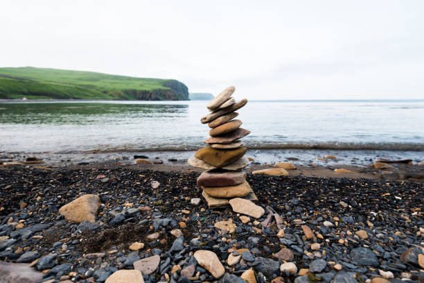 Stones pyramid on the seashore. stock photo
