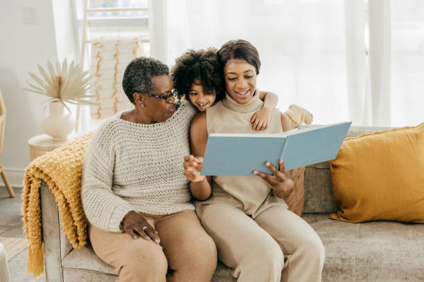 preparing your family for the future - family reading african descent book imagens e fotografias de stock