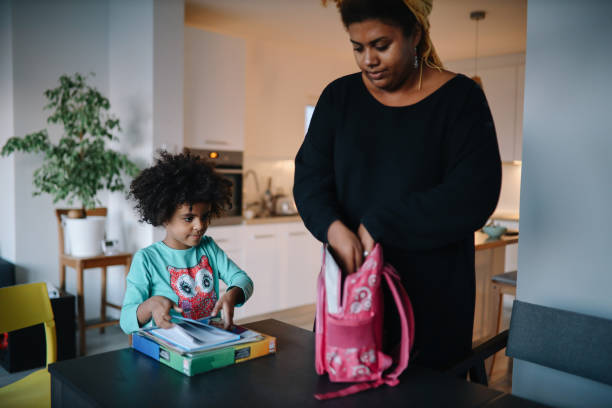 istock Mom and daughter preparing stuff for school 1352163520