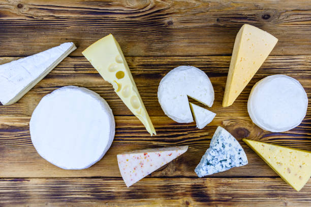 istock Various types of cheese on a wooden background. Top view 1352163627
