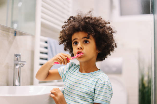 Morning routine before school Young girl getting ready for school, doing the morning routine in the bathroom. toothbrush photos stock pictures, royalty-free photos & images