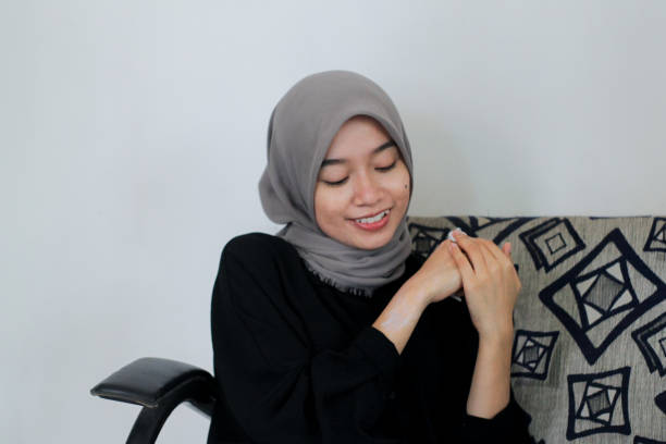 istock young women using skin care at home 1352165467