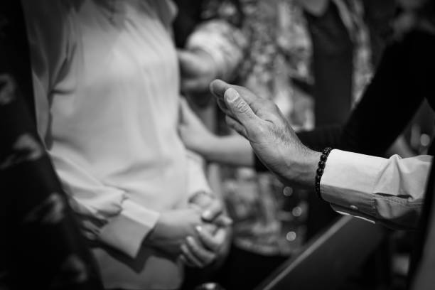istock People praying together at church. 1352166411