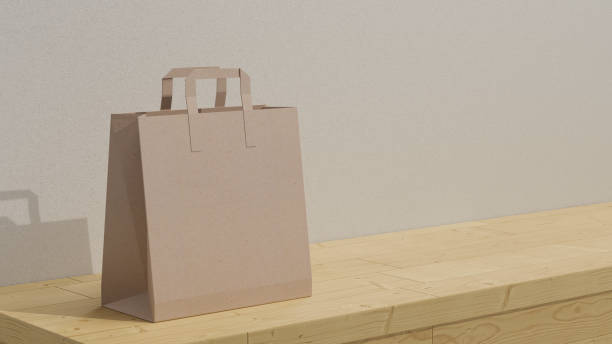 коричневый макет сумки для покупок на деревянном прилавке на белом фоне стены. - bag white paper bag paper стоковые фото и изображения