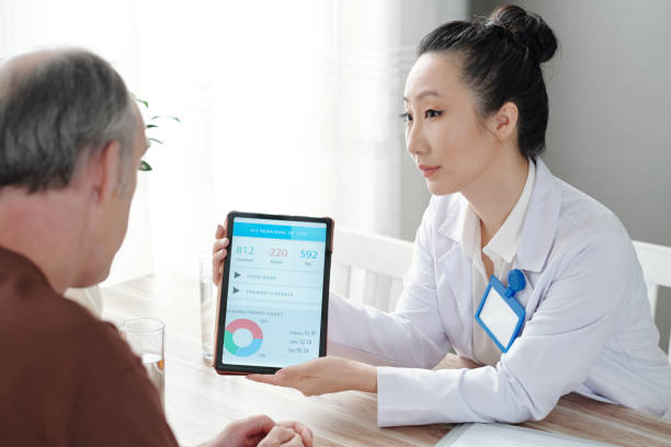 istock Doctor Showing New App To Patient 1352169038