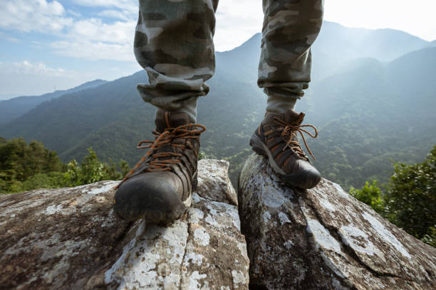 istock Successful hiker enjoy the view on mountain top cliff edge 1352171407