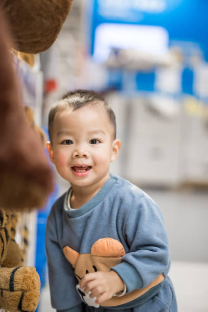 istock Little boy playing in market 1352172000
