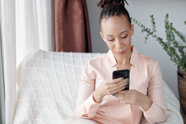 istock Woman Answering Text Messages 1352172794