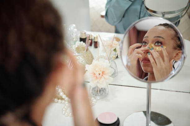 istock Woman Applying Undereye Patches 1352172889