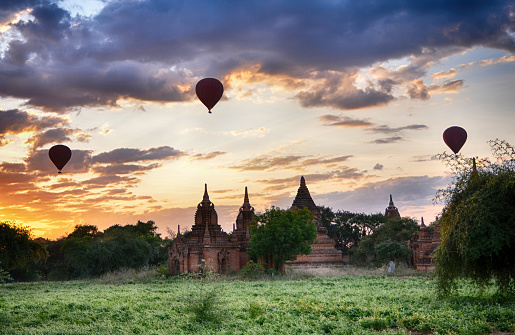 Dawn of Ancient Buddhism temples Archeological Zone and hot air balloons in Bagan, Myanmar