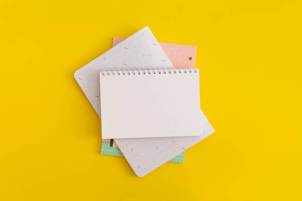 istock Notebook on yellow background. Top view. Flat lay. Back to school concept. 1352173641