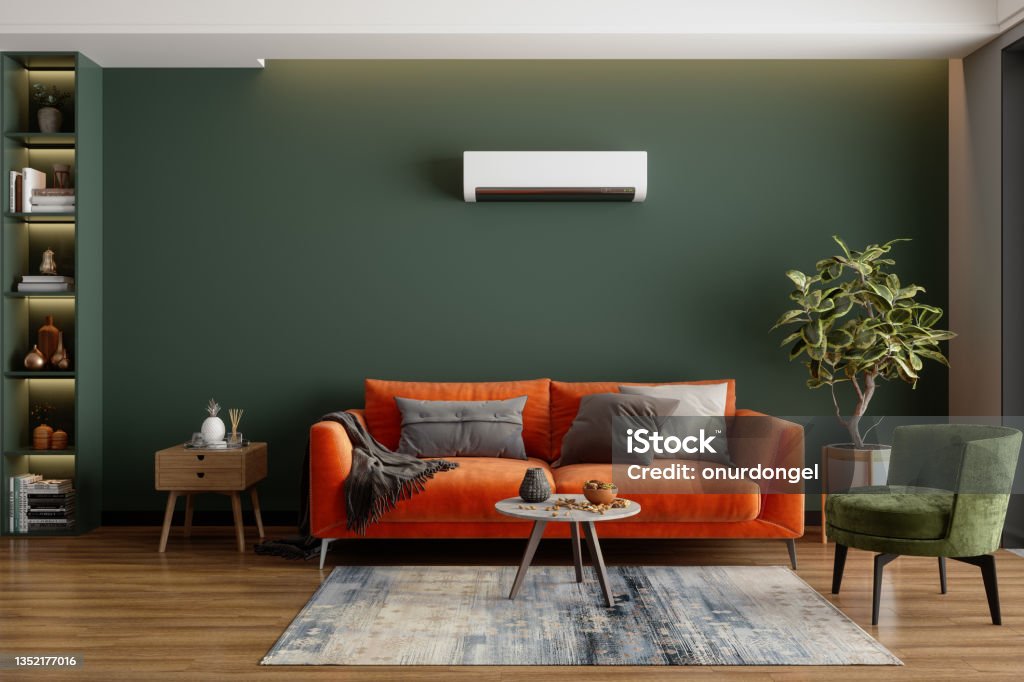 Modern Living Room Interior With Air Conditioner, Orange Sofa And Green Armchair Living Room Stock Photo