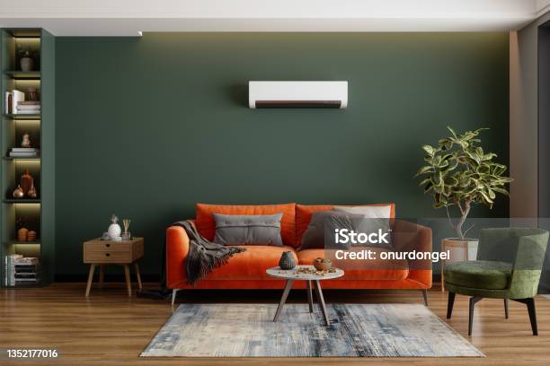 Modern Living Room Interior With Air Conditioner Orange Sofa And Green Armchair Stock Photo - Download Image Now