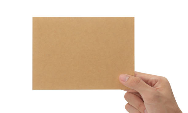 istock Hand holding blank cardboard paper isolated on white background with clipping path, Greeting card mockup 1352181744