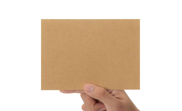 istock Hand holding blank cardboard paper isolated on white background with clipping path, Greeting card mockup 1352181748