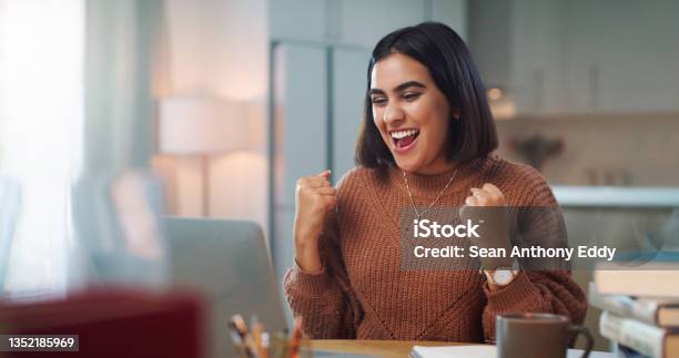 Shot Of A Young Woman Cheering While Using A Laptop To Study At Home Stock Photo - Download Image Now