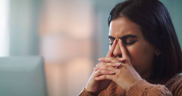 istock Shot of a young woman looking stressed out while using a laptop to study at home 1352185972
