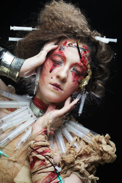 istock Young woman with creative make up. Halloween theme. Zombie theme 1352188635