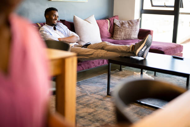 istock Young man watching TV with feet up 1352189082