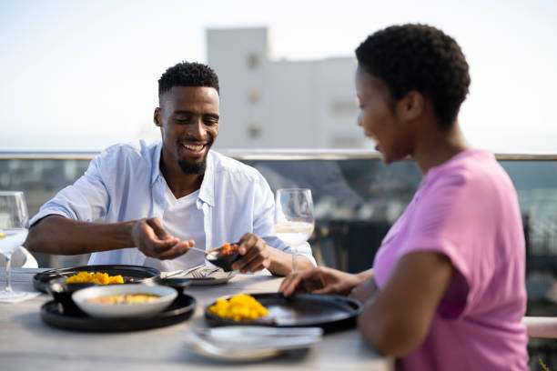 istock Couple enjoying lunch on rooftop outdoor cafe 1352189111