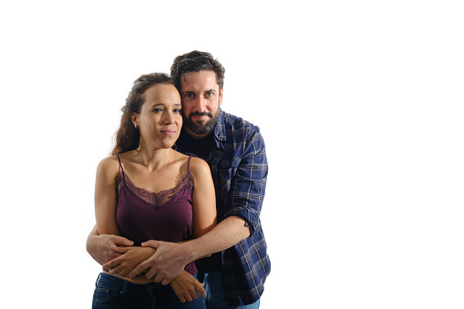 Studio portrait of an affectionate senior couple posing against a grey background