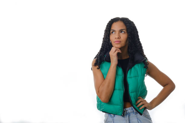 istock Thoughtful woman with hand on her chin and looking away while thinking something. 1352191629