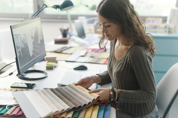 istock Professional decorator choosing fabric swatches 1352194722