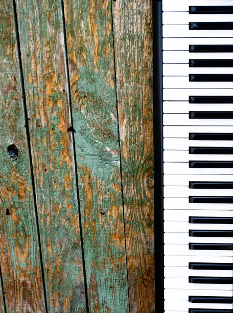 Piano Keyboard on the Old Wooden Planks Background